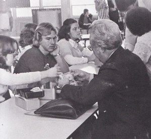 Donna Moore, Jackie Audrain, Scott Fedosky and Kathy Trice aid in raking in the money during cap and gown measurements.